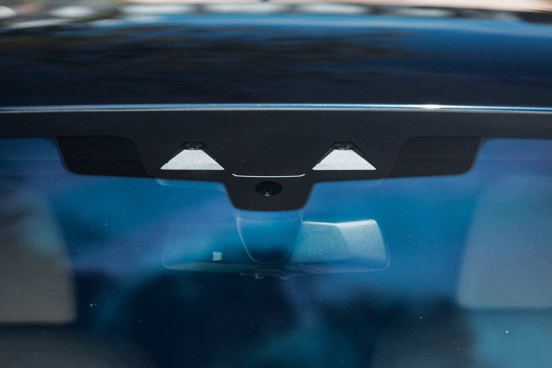Forward-facing camera module behind a car windshield